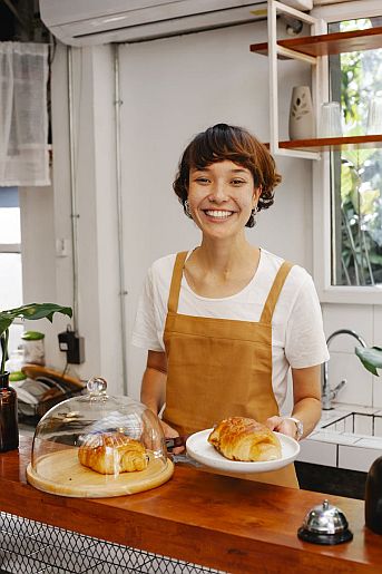 Woman Serving Croissants